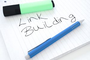 Link Building - handwritten text in a notebook on a desk - 3d render illustration.